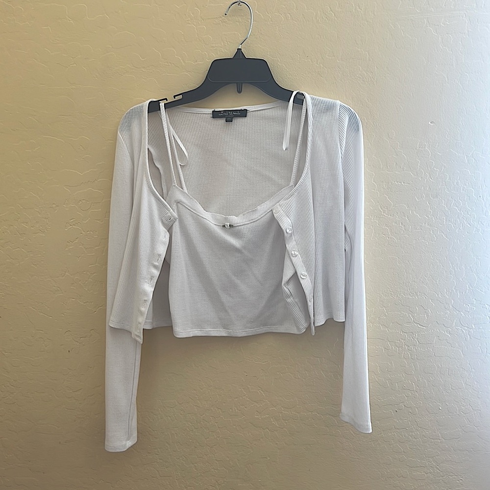It’s a cute medium white tank top paired with a cropped bottom up sweater